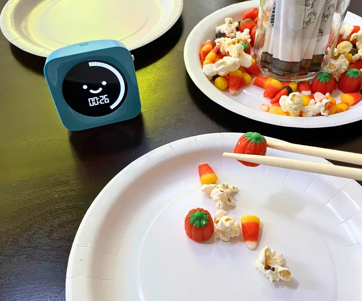 blue timer showing 26 seconds left, with person using chopsticks to put more on her plate