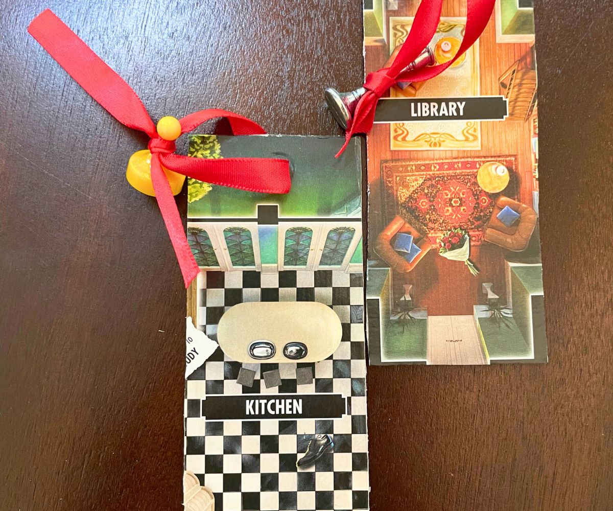 two finished Clue board game bookmarks, with a red ribbon in each tied around game piece