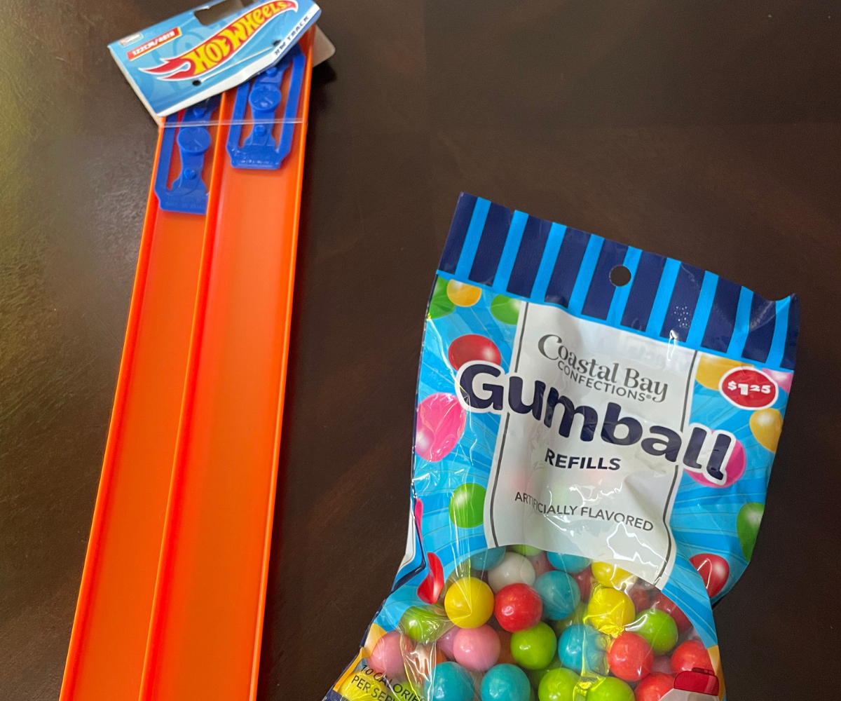 Hot Wheels orange tracks next to bag of colorful gumballs