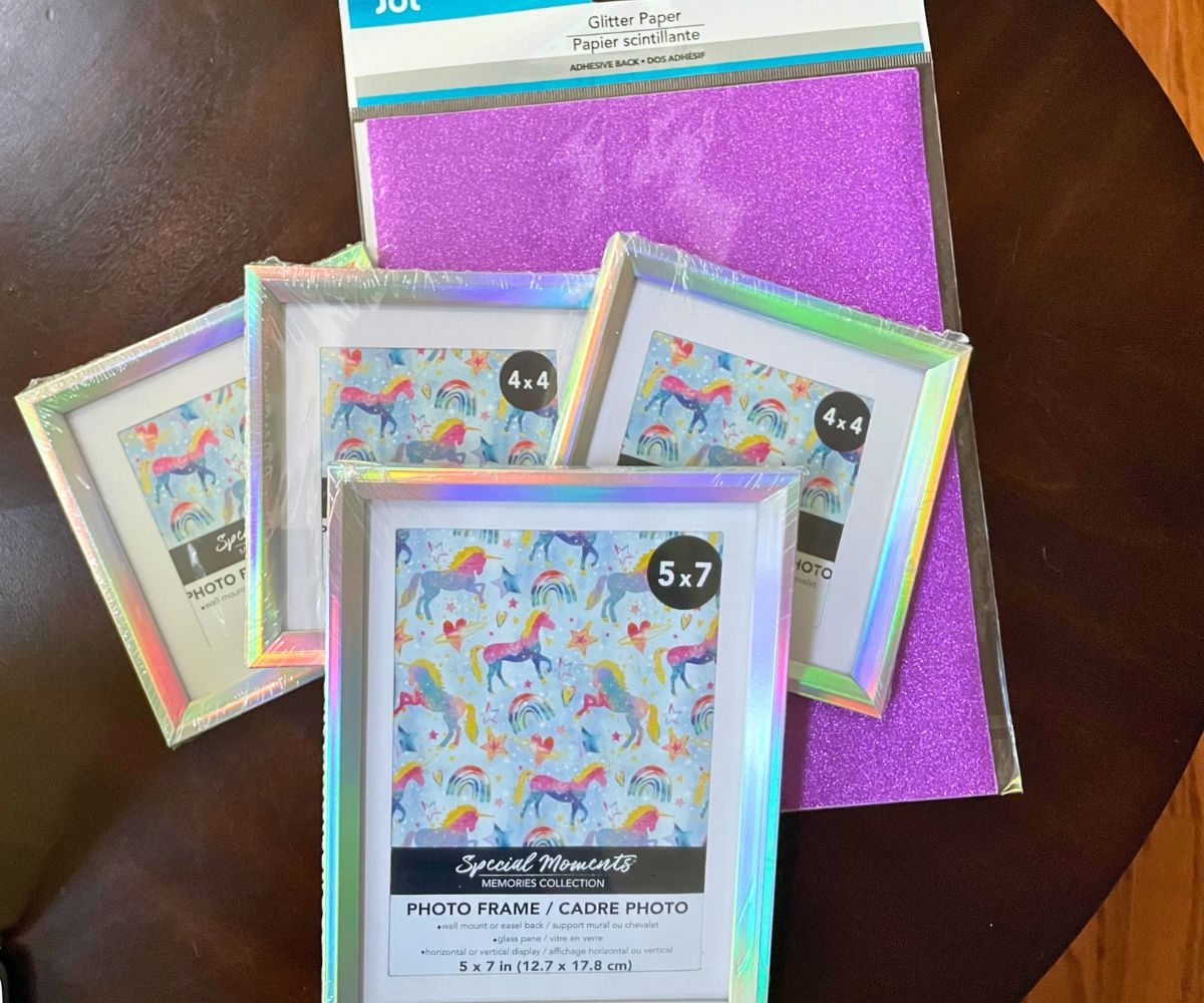 four picture frames in rainbow hologram colors, and purple sparkly paper