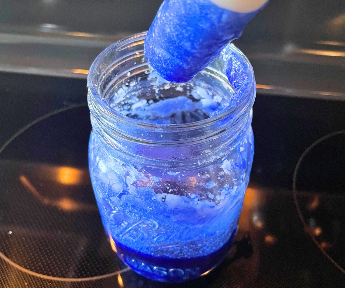 deep blue melted wax with white long candle dipped in