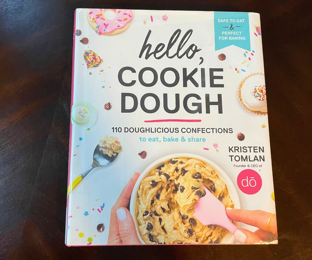 pastel colored book hello, cookie dough, on dark table