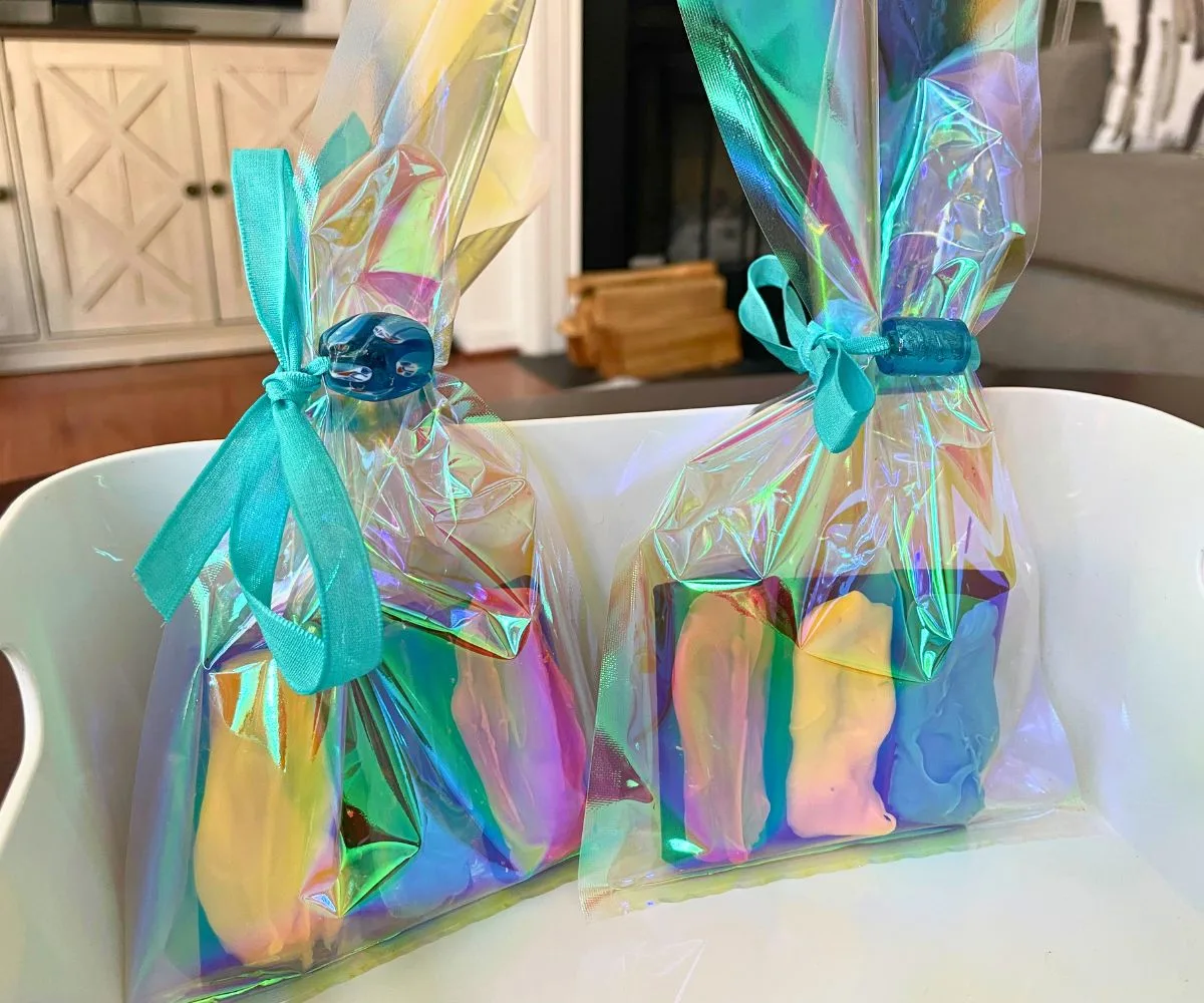 two rainbow chocolate half-bars in two packages with beautiful blue glass bead tied around front