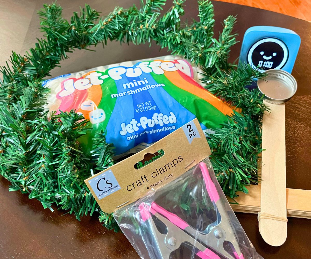 wreath, mini marshmallows, timer, homemade catapult, and craft clamps