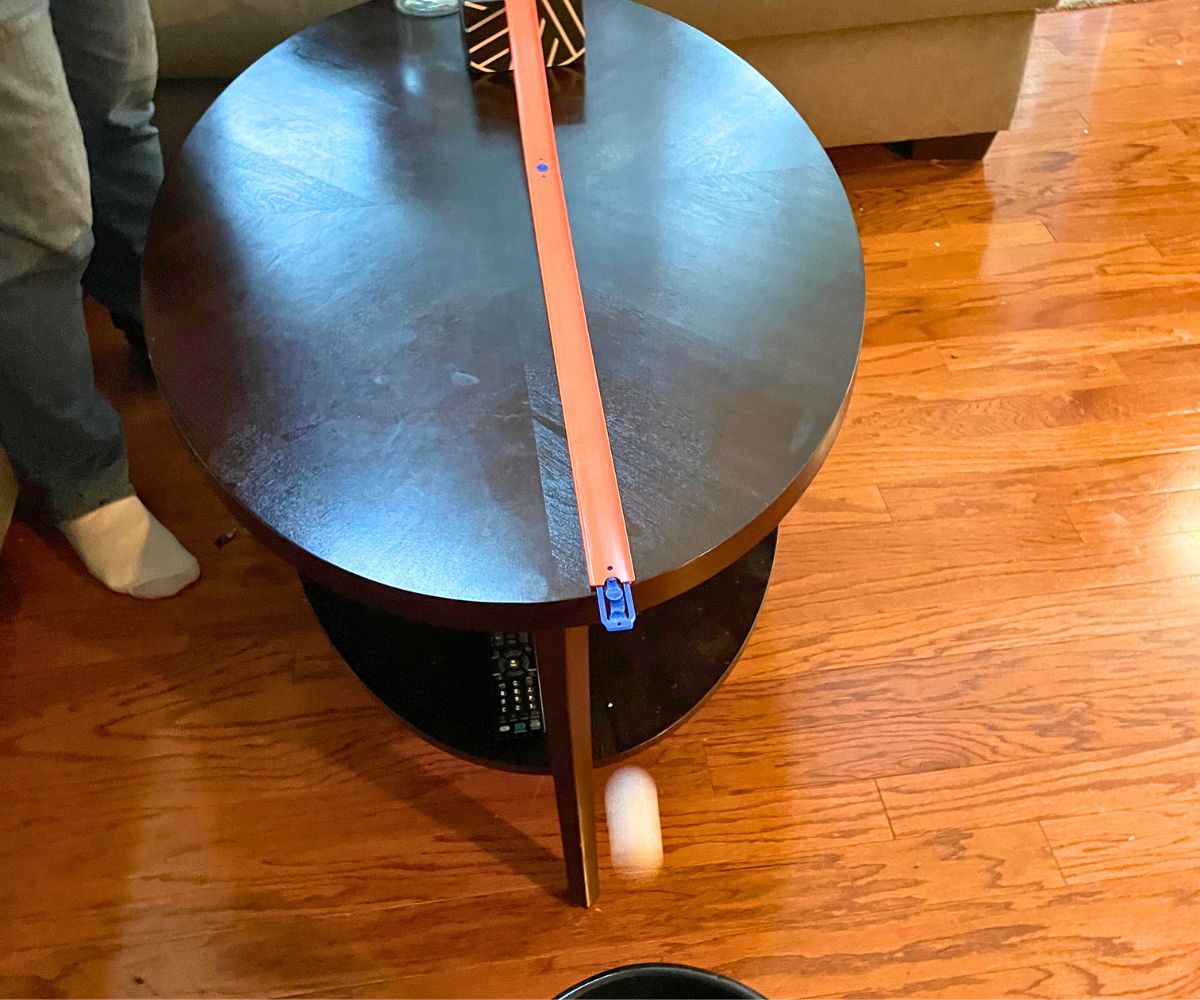 ping pong ball in motion into bucket on ground