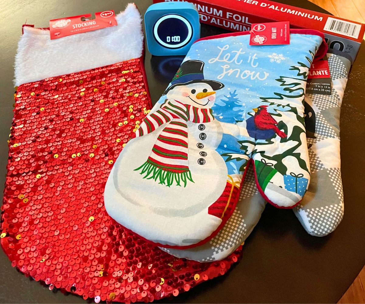 red sequin stocking and two oven mitts, timer, and aluminum foil
