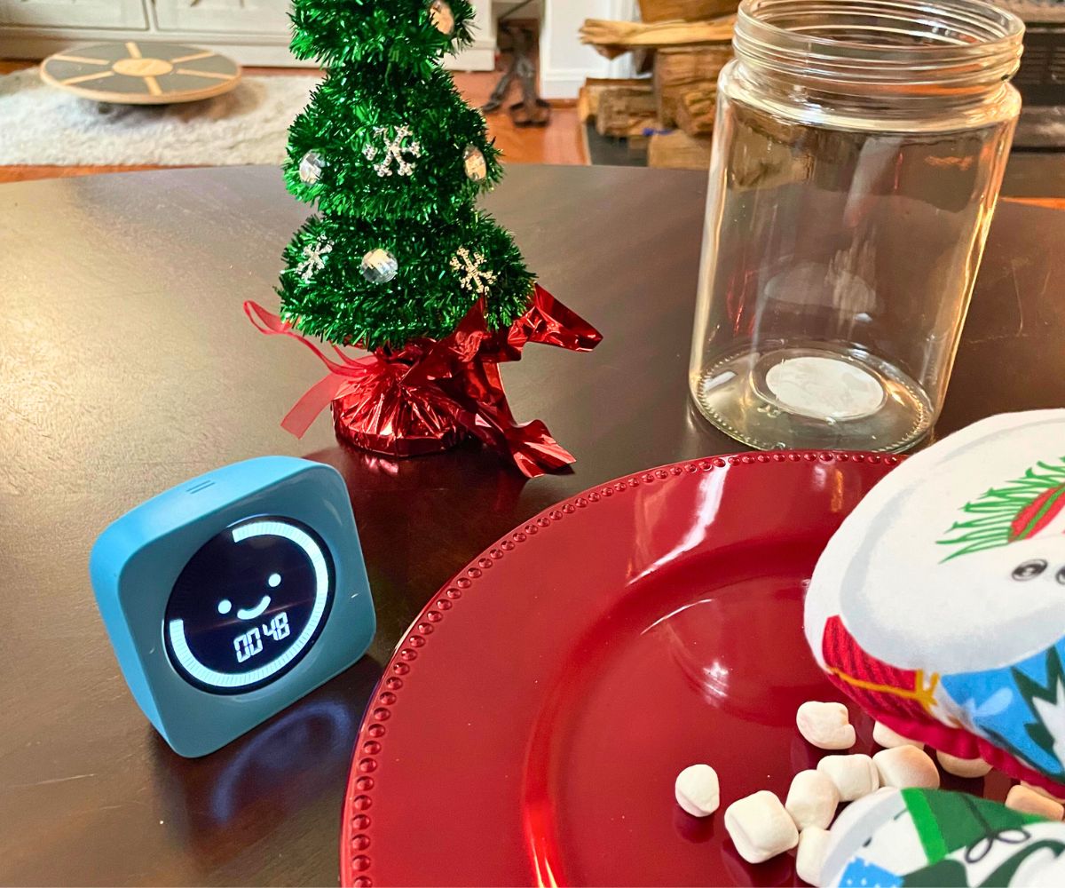 oven mitt on hand grabbing a mini marshmallow with jar, and timer showing 48 secs. left