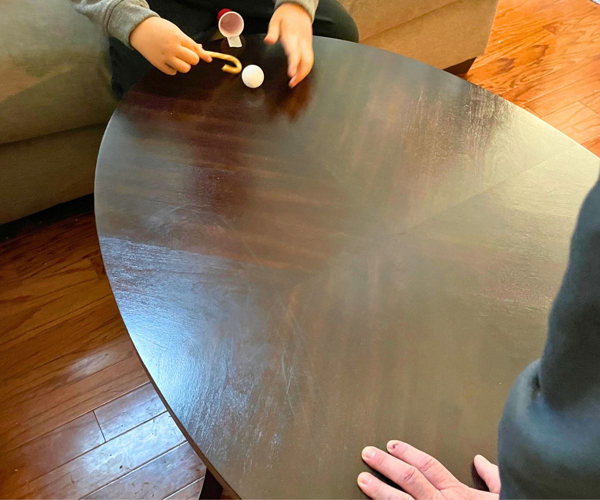 two players on each side of a dark table playing the candy cane game for kids