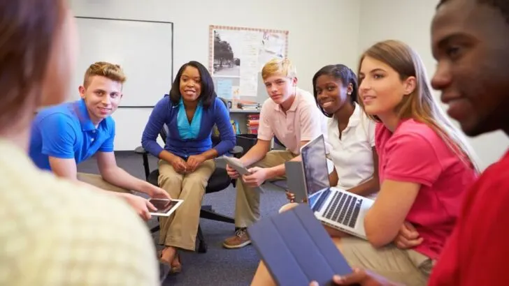 circle of high school business class students doing fun activity