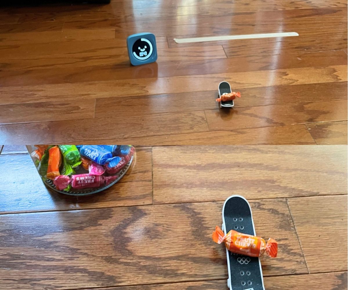 split shot showing candy on tech deck mini skateboard racing towards masking tape finish line