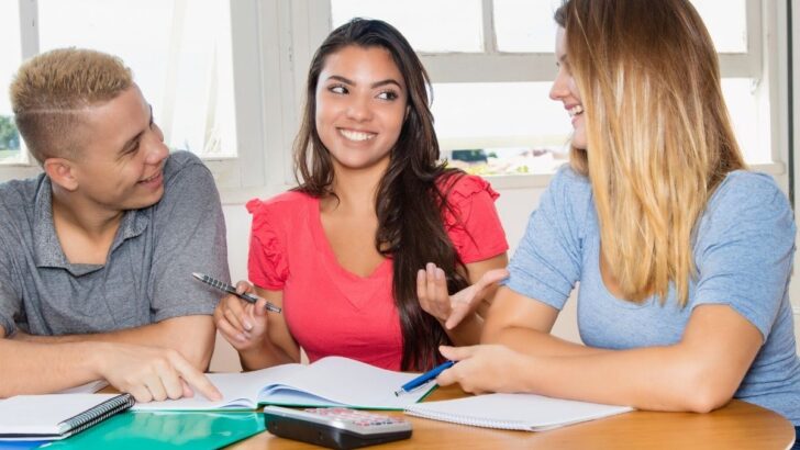 three teen business students doing an activity