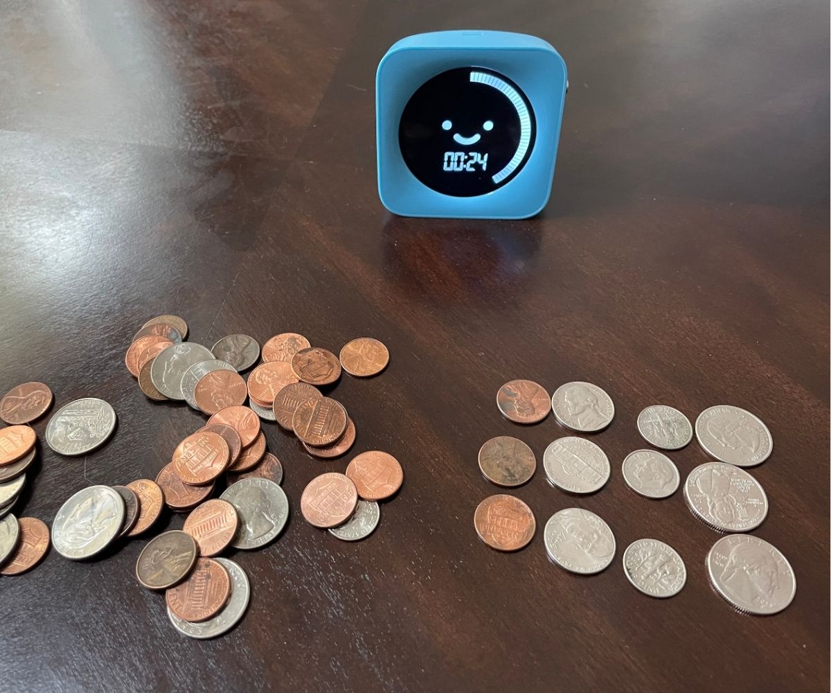 a bunch of coins, and four rows with coins valued from penny to quarter with timer in background