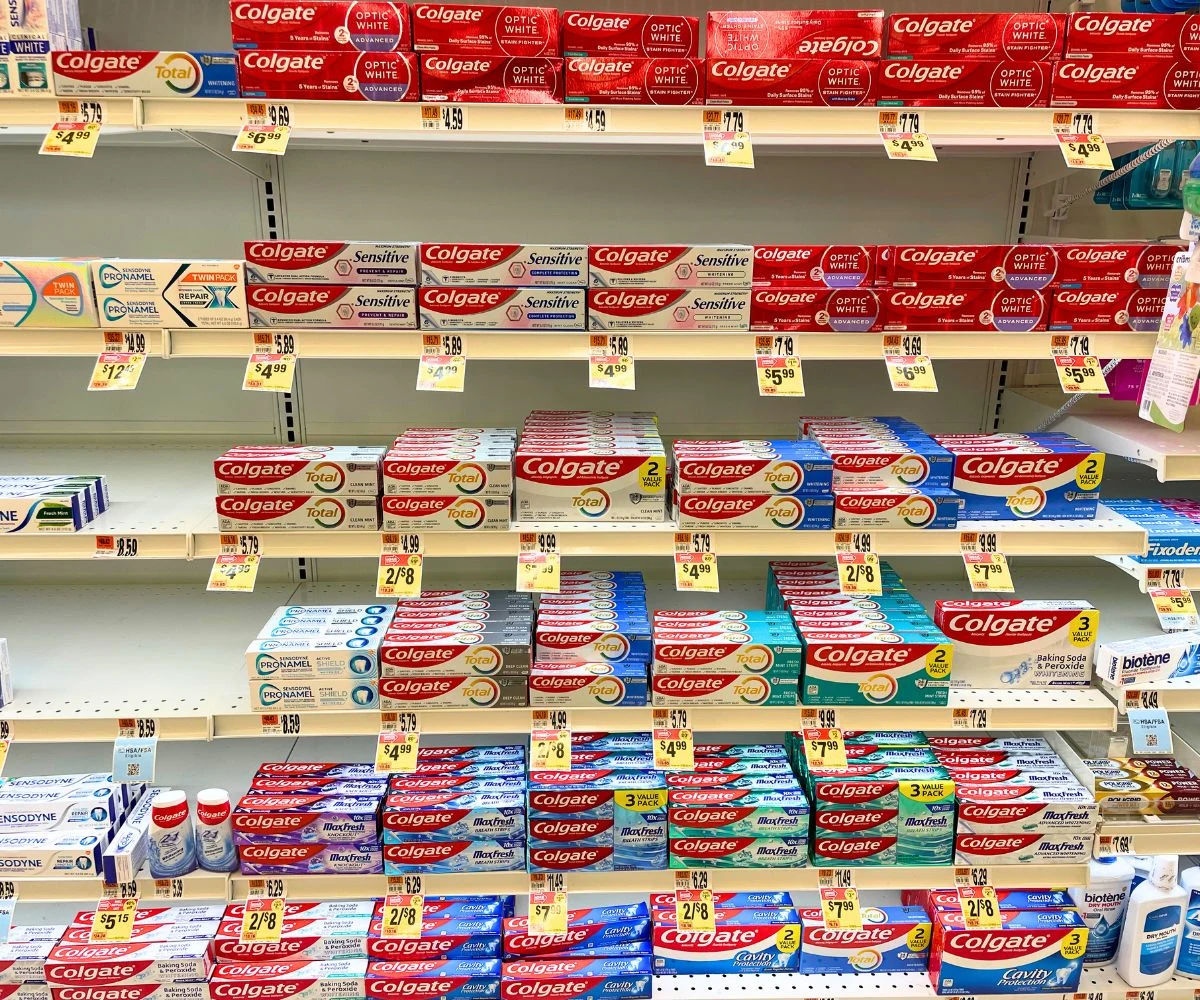 shelf absolutely filled with tons of toothpastes