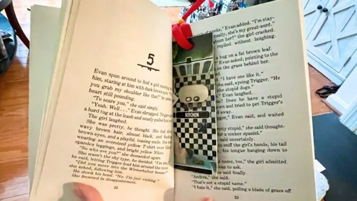opened preteen book with gameboard bookmark in it