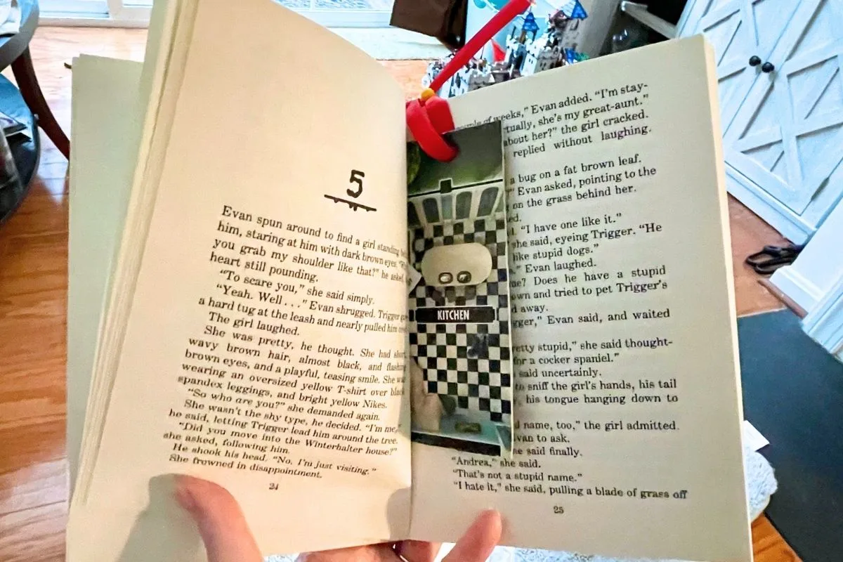 opened preteen book with gameboard bookmark in it