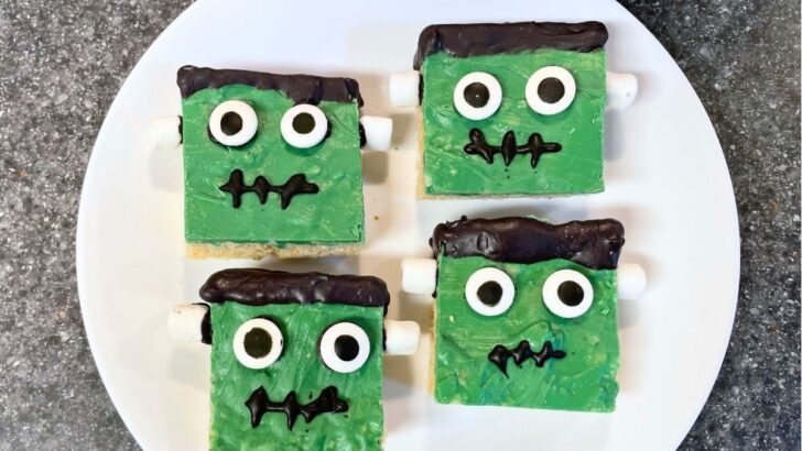 green and black frankenstein krispies treats on white plate