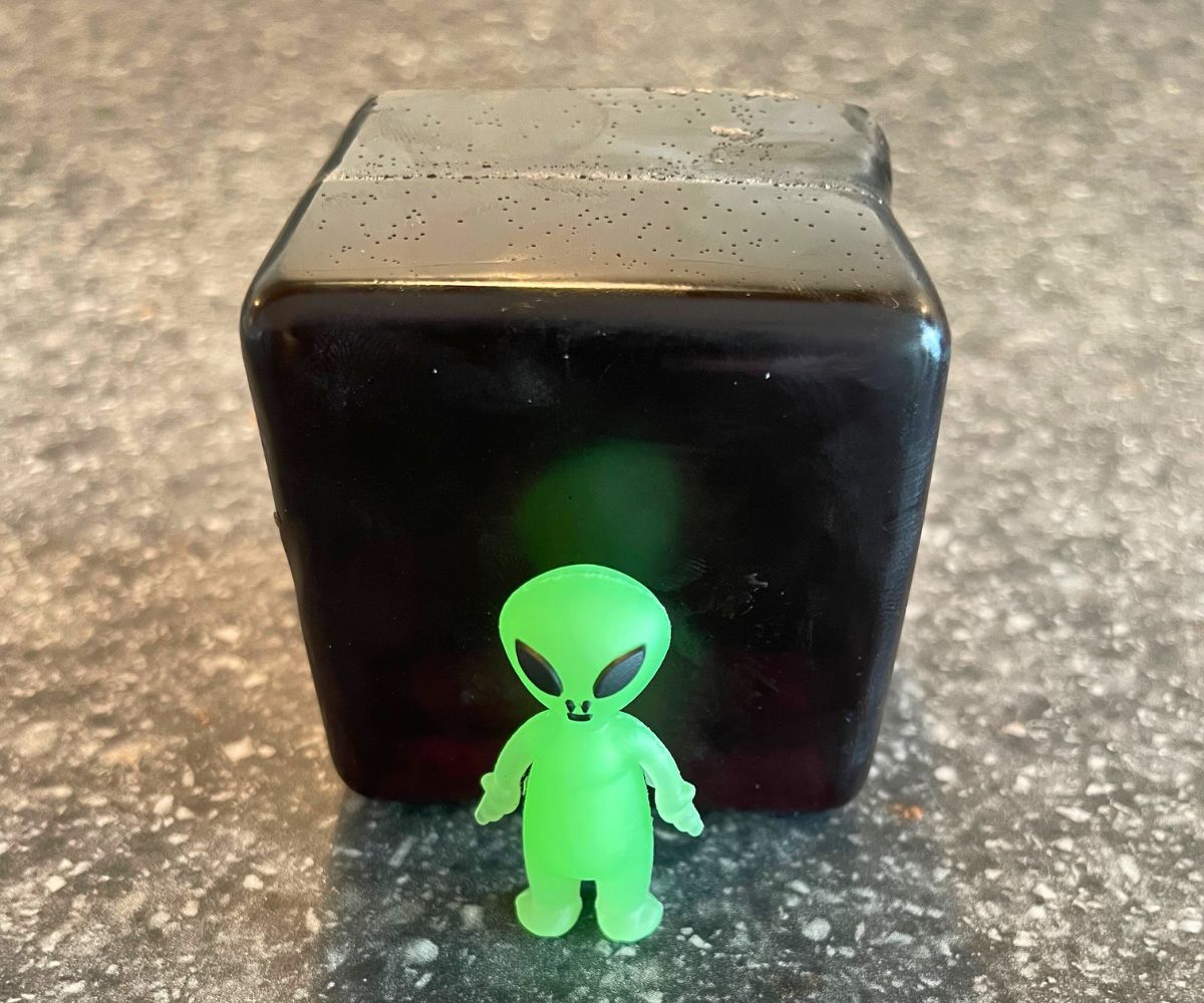 black cube of soap with glow in the dark alien on outside (to show what's inside)