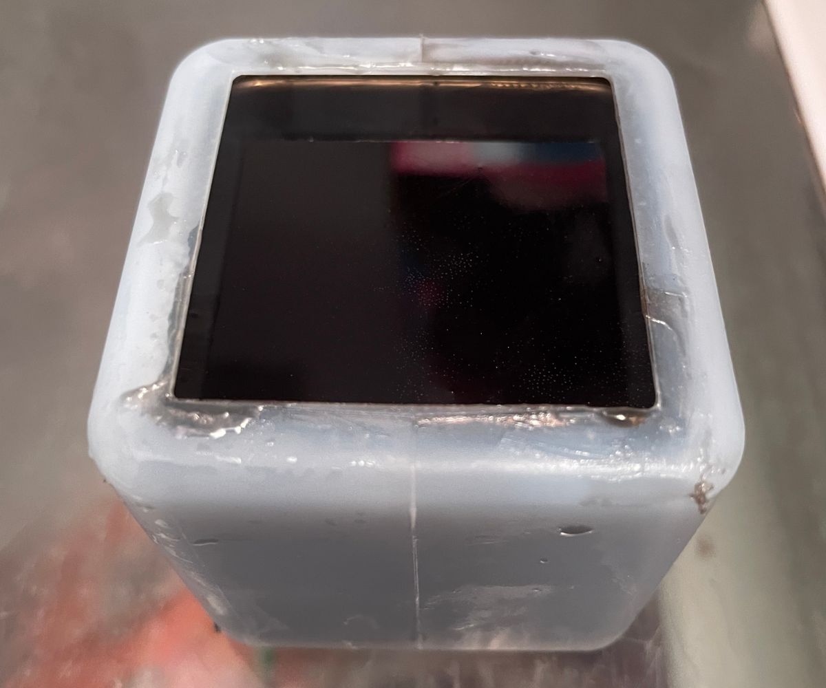cube mold filled to top with black soap
