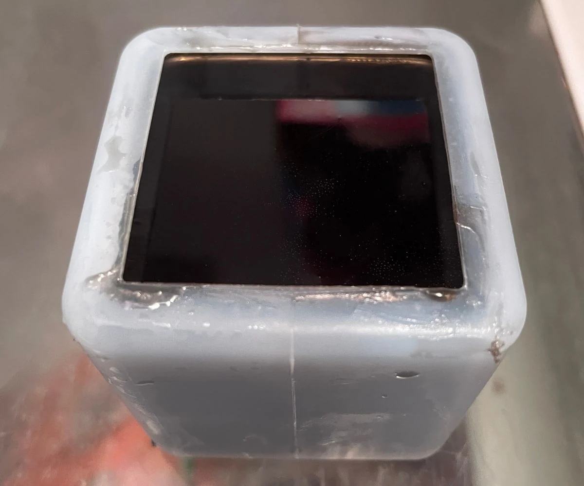 cube mold filled to top with black soap
