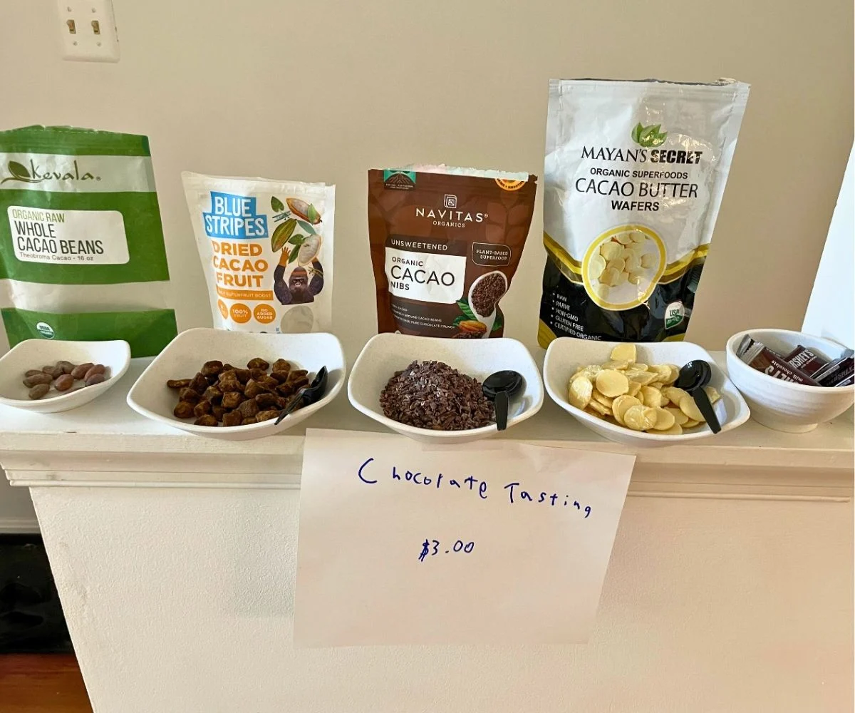 display chocolate at different processing stages, whole cacao beans, dried cacao fruit, cacao nibs, cacao butter, and mini hershey's chocolate bars
