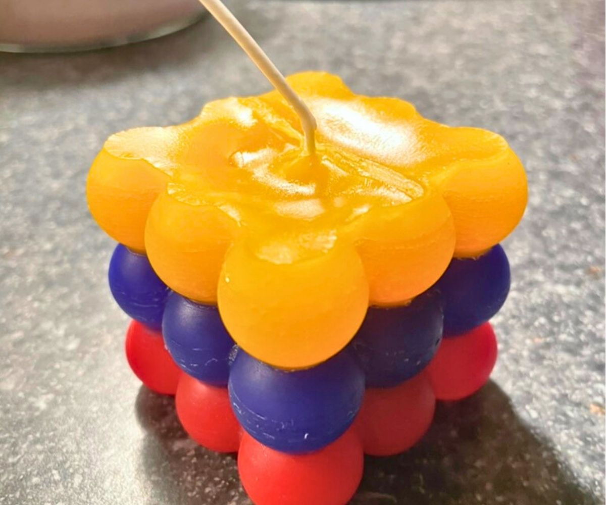 candle with three layers of bubbles, yellow, blue, and red