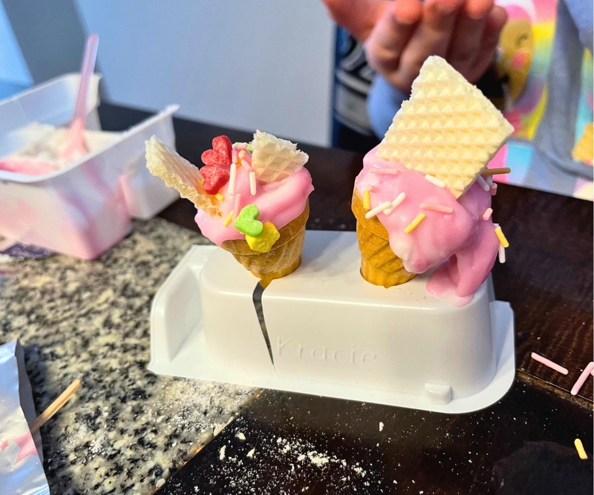 white holder with two mini ice-cream cones filled with pink fake ice-cream (edible candy)