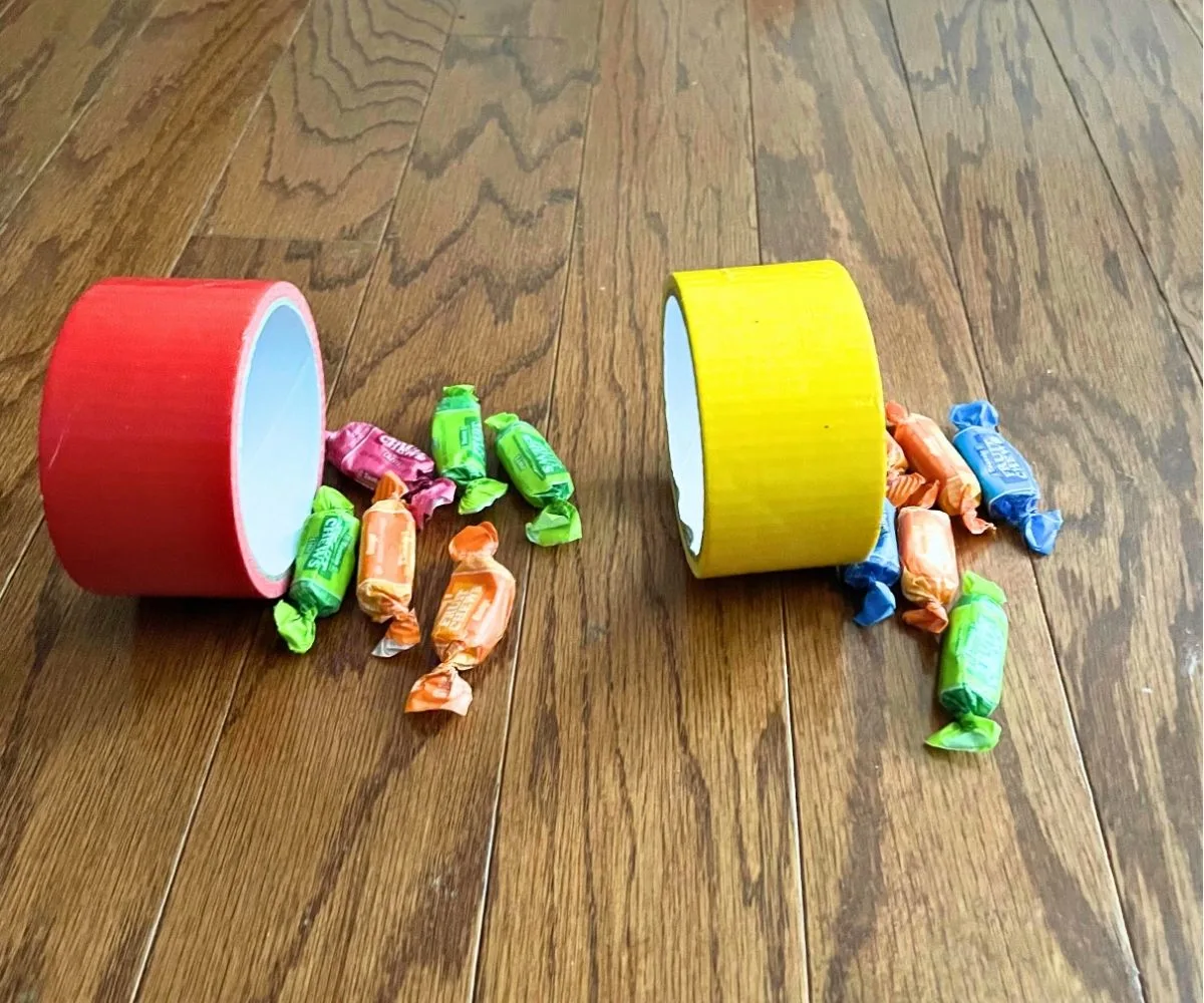 red and yellow duct tape roles with pieces of candy beside them, getting ready for play