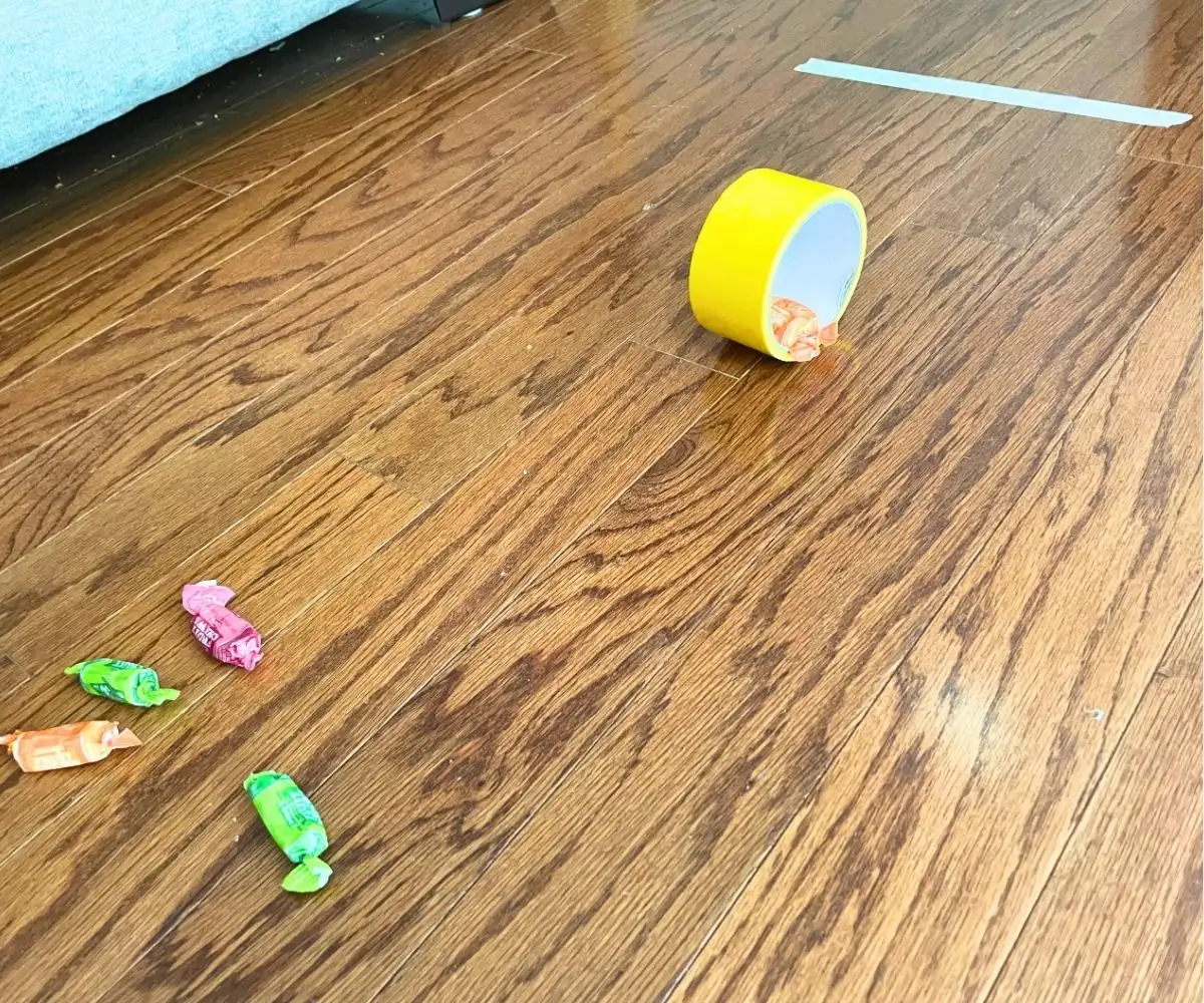 yellow duct tape roll with candy sticking out, working towards a masking tape finish line