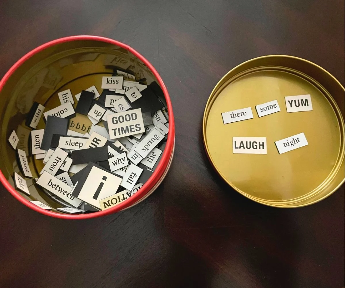 tin container opened with magnetic poetry pieces inside of it