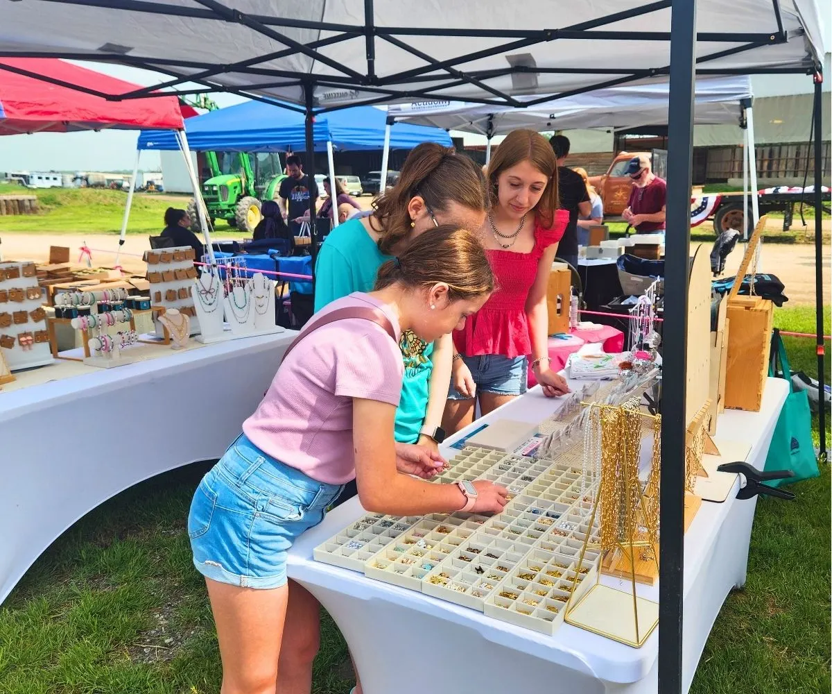 Ava teen business owner at her booth with customers