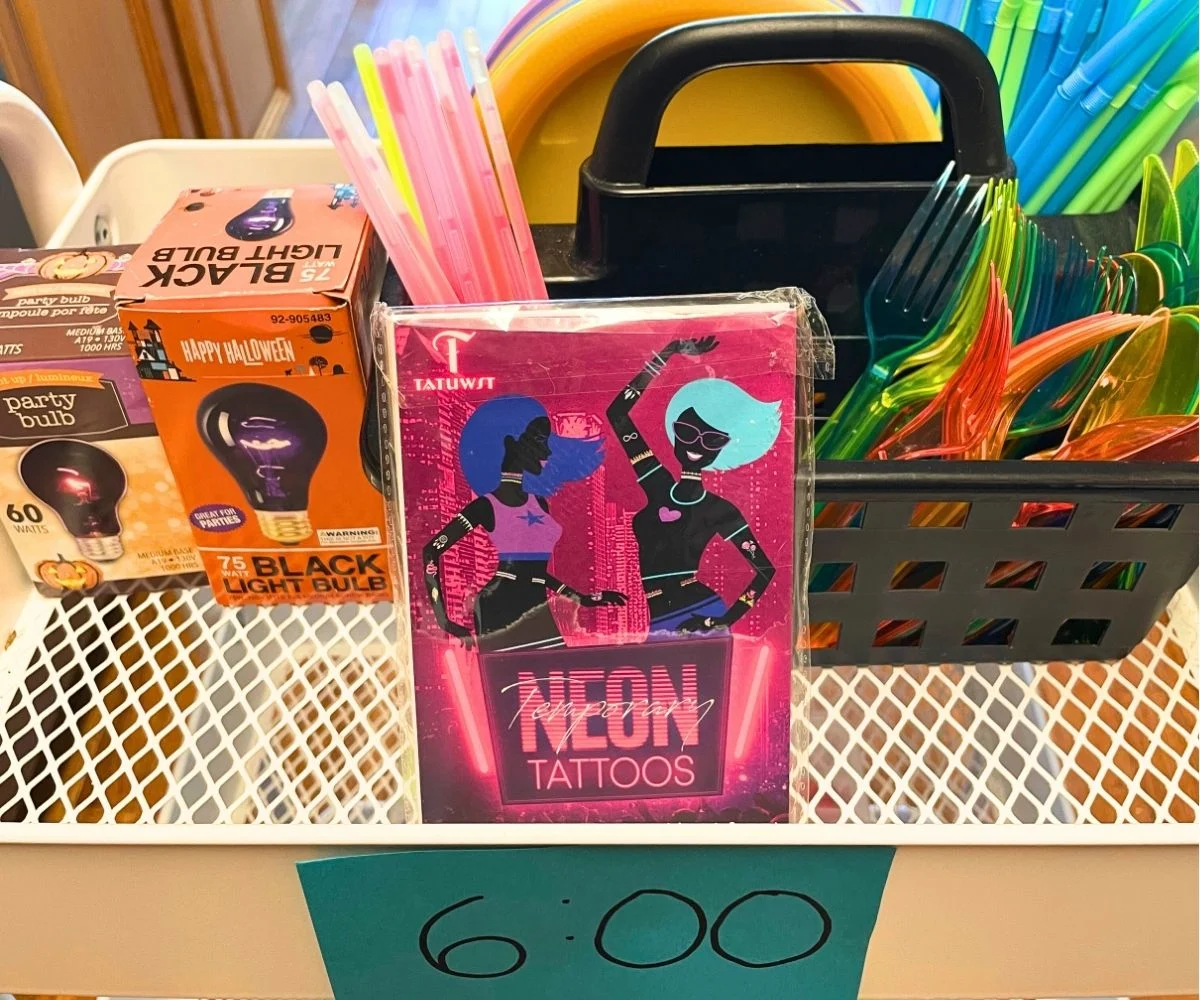 6:00 p.m. top tier filled with black light supplies and reactive plastic dinnerware