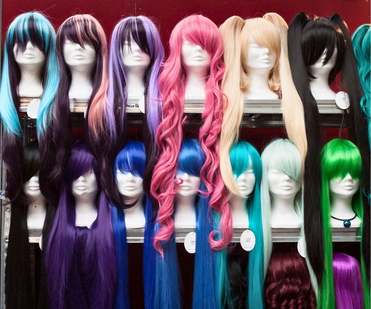 tons of colorful wigs on head mannequin displays