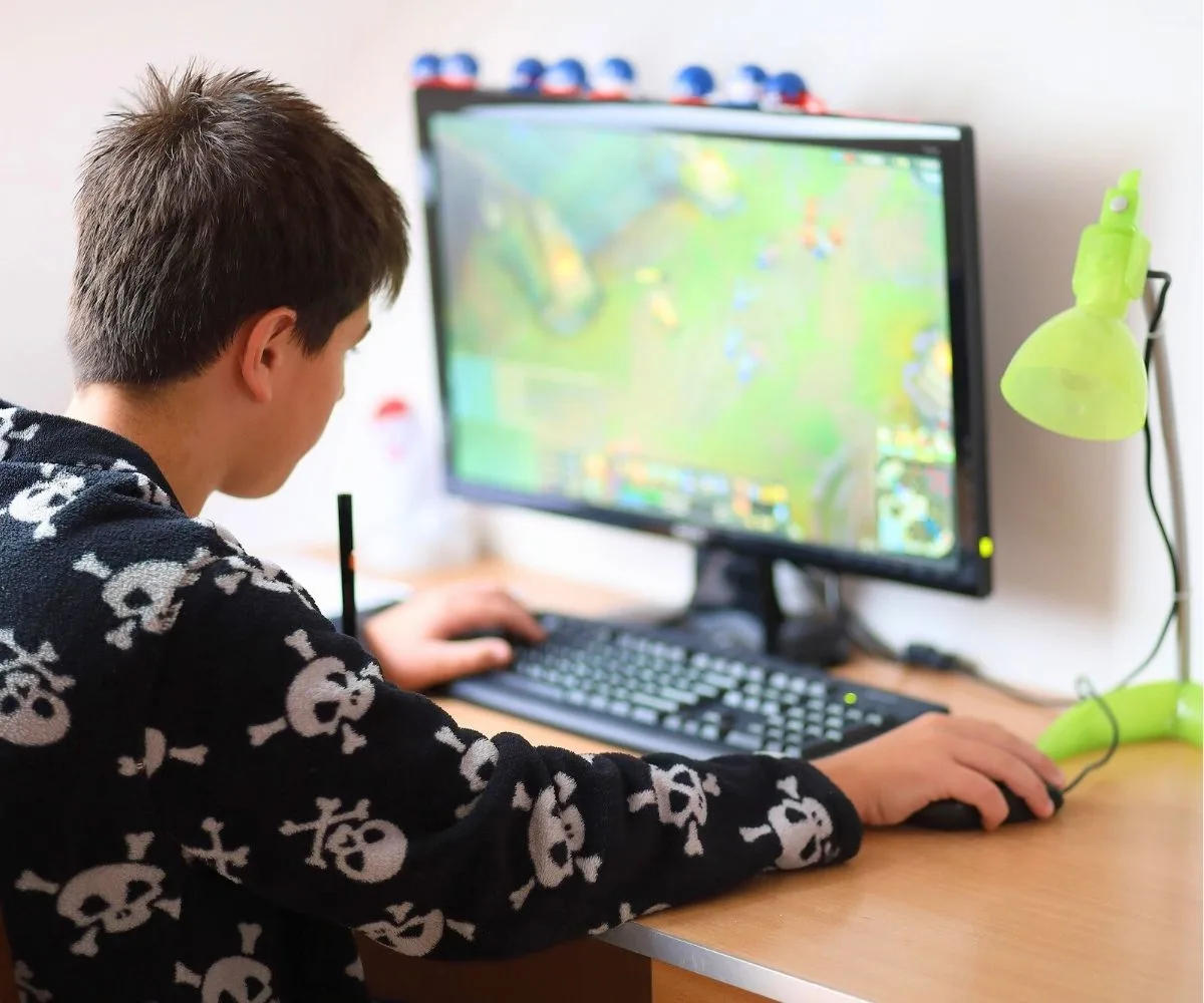 teen boy on computer creating Roblox game