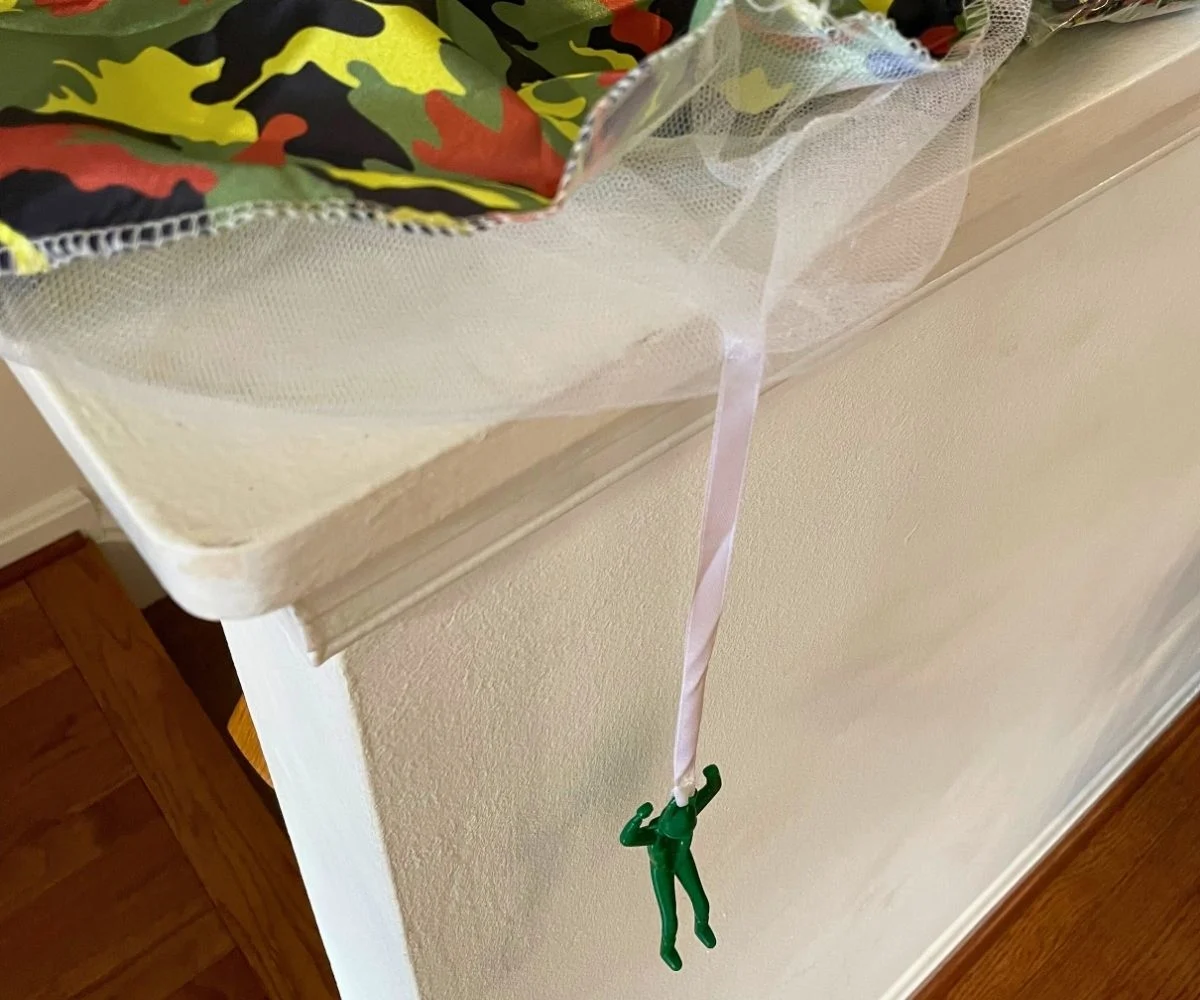 army man with parachute dangling off a banister