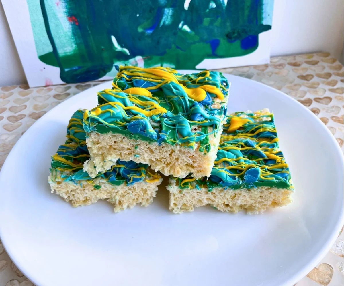 three really colorful graffiti covered Rice Krispies treats on white plate