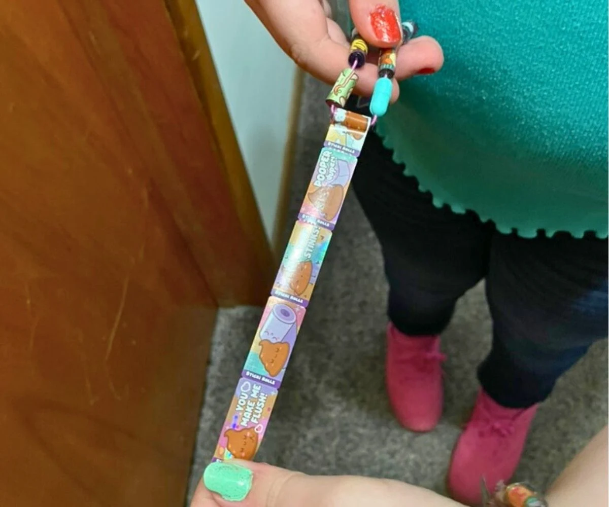 tween girl stretching out one of the Sticki rolls on the bracelet to show lots of stickers to choose from