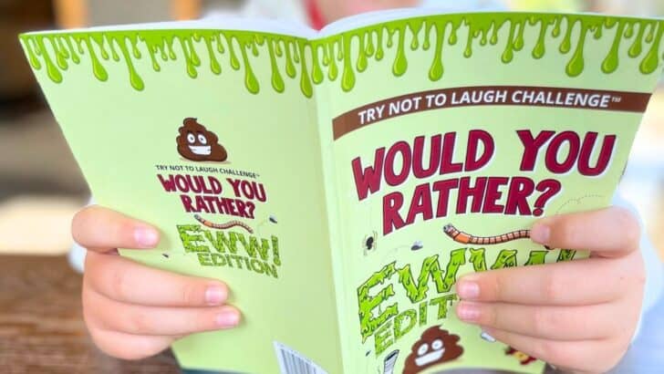 tween boy reading Would You Rather Ewww Edition book as Christmas gift