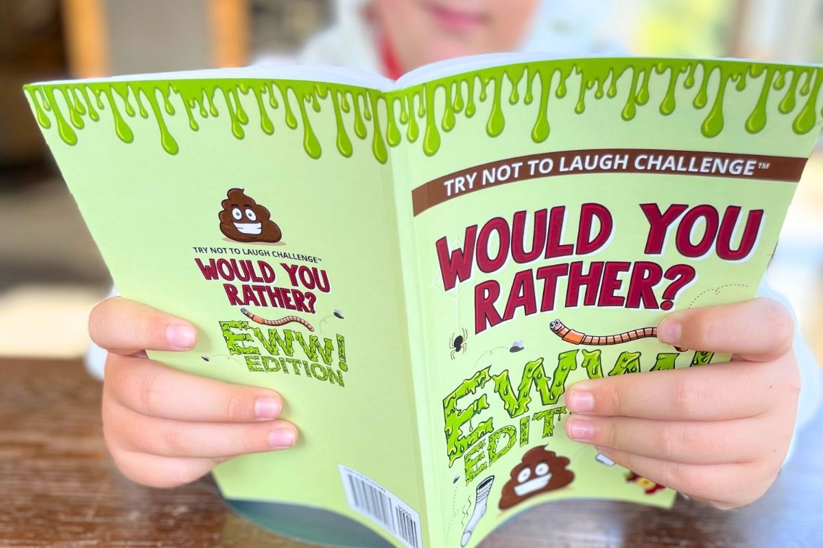 tween boy reading Would You Rather Ewww Edition book as Christmas gift