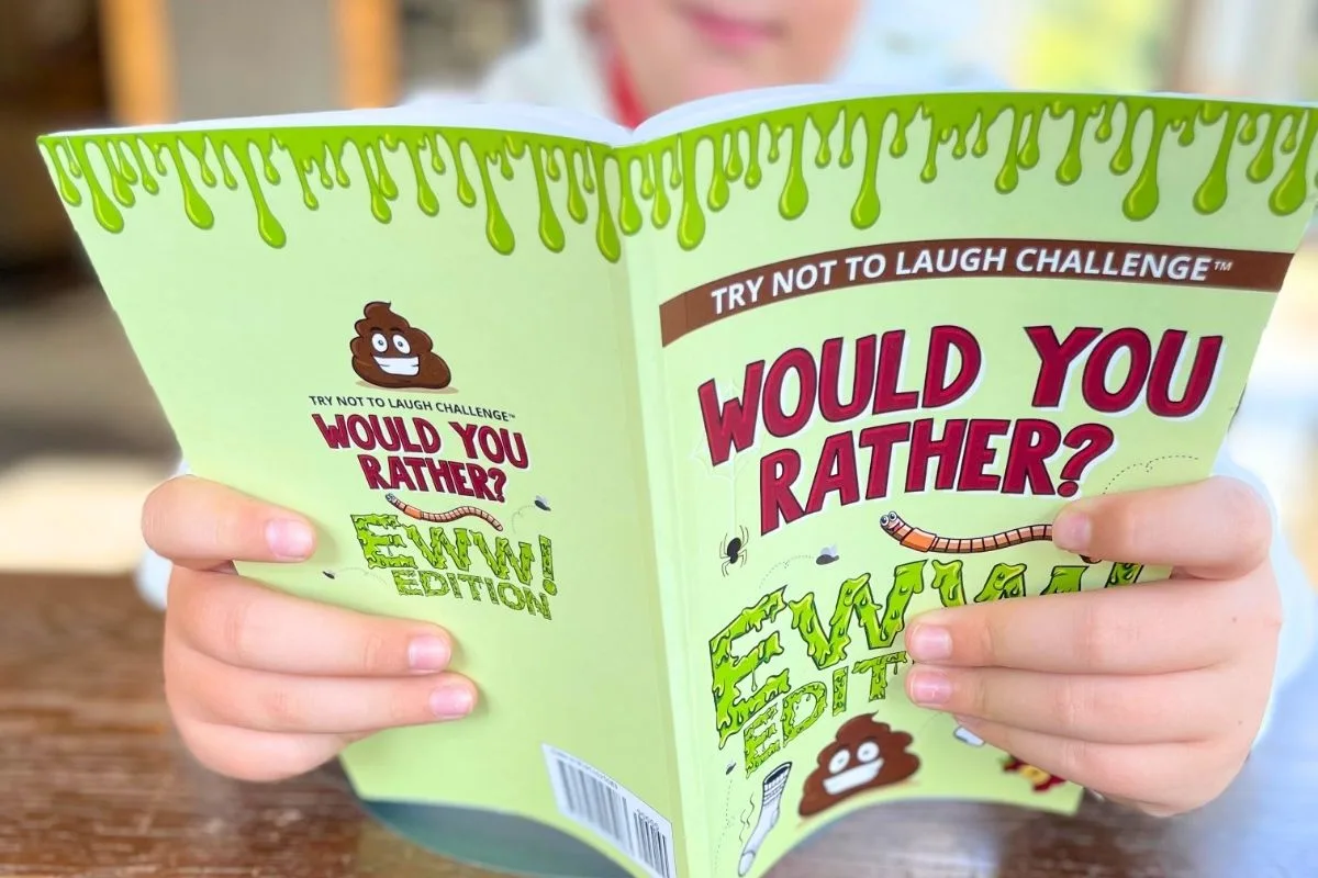 tween boy reading Would You Rather Ewww Edition book as Christmas gift