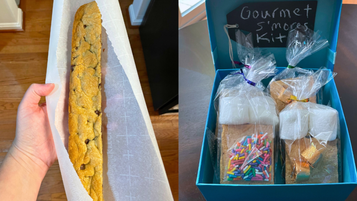 blue box with prepackaged gourmet s'mores kits in it, and a foot long cookie bar in someone's hand