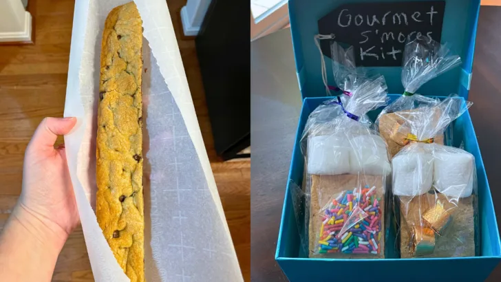 blue box with prepackaged gourmet s'mores kits in it, and a foot long cookie bar in someone's hand