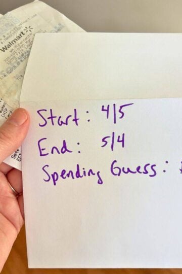 woman holding envelope and receipts with dates on the outside of it and estimated $47 in spending