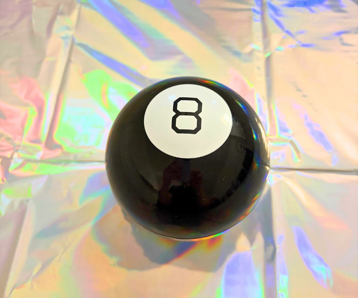 rainbow colored tablecloth with magic 8 ball on top