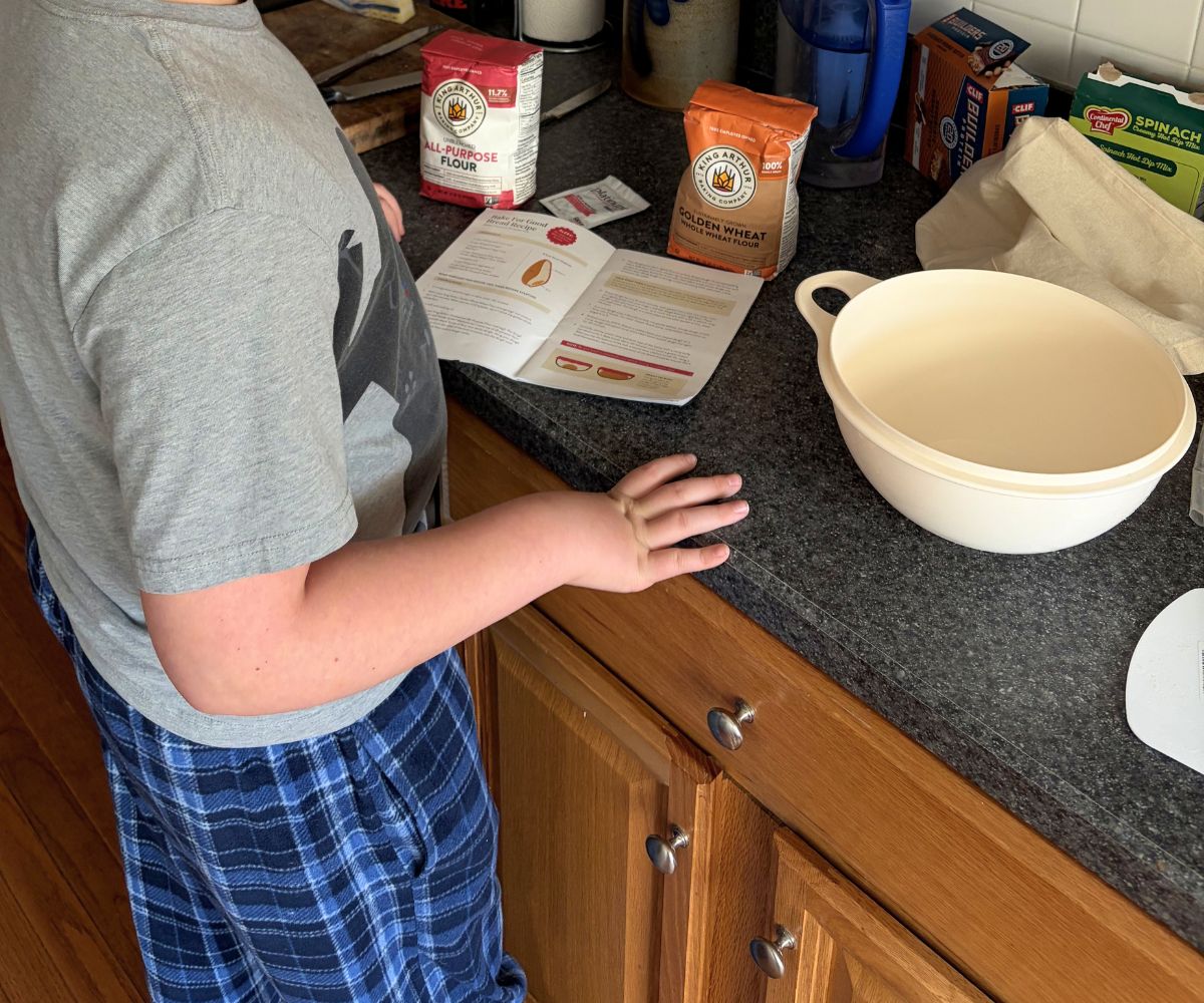 child with free King Arthur baking set at home, baking bread