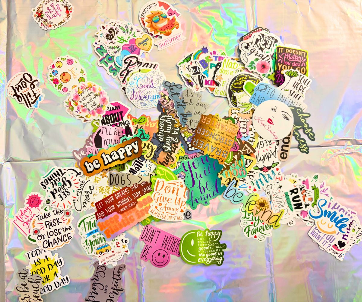 rainbow colored table cloth filled with pile of positive vinyl stickers to choose from