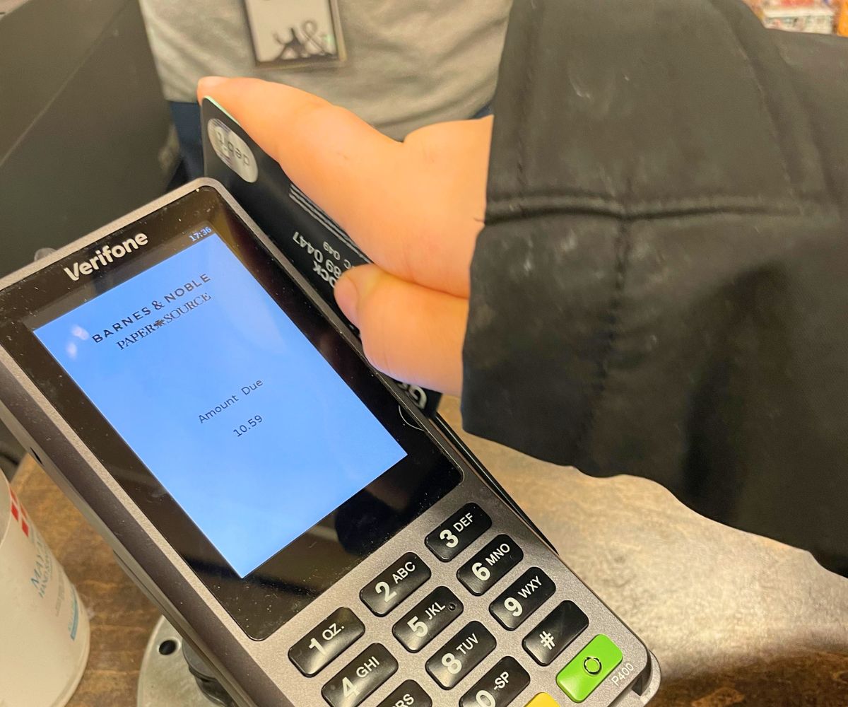 child making a transaction at Barnes & Noble with a Greenlight prepaid debit card for kids